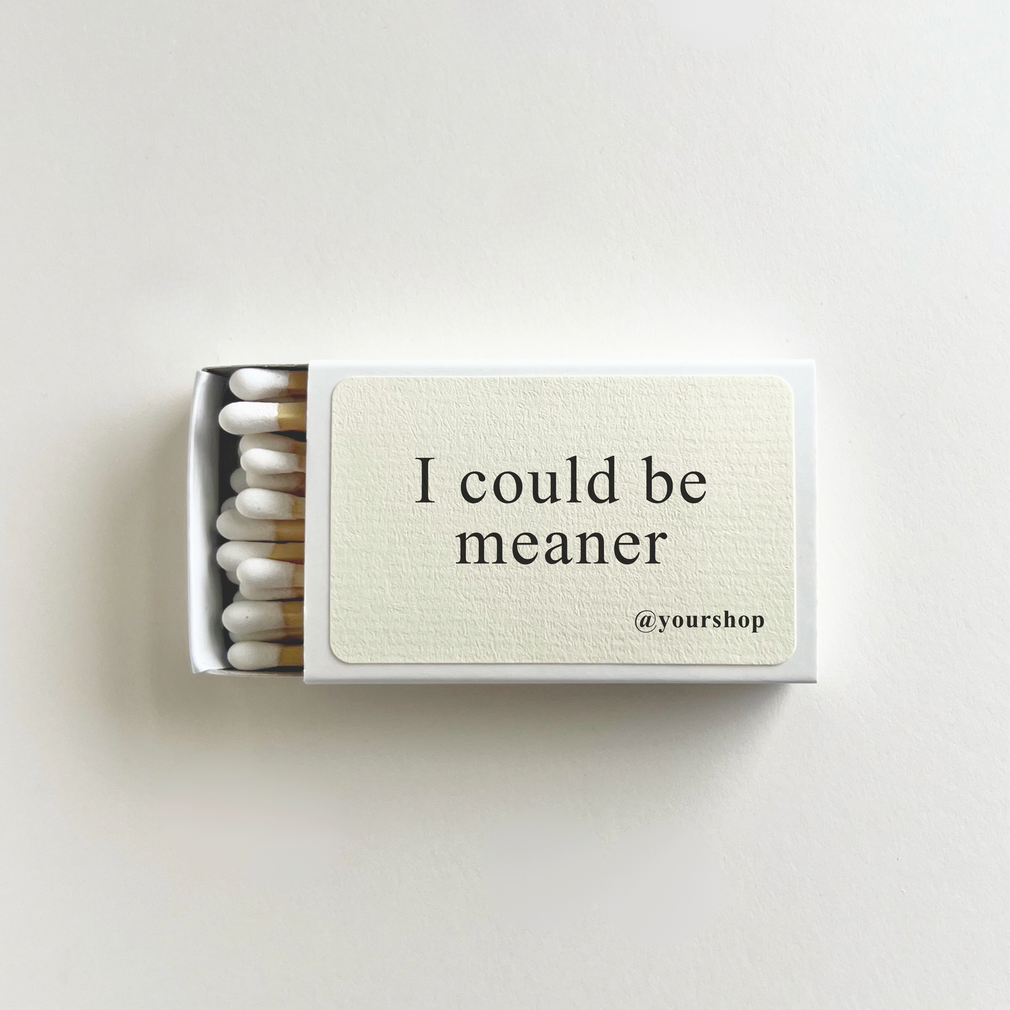 Matchbox with 'I could be meaner' text on a white background
