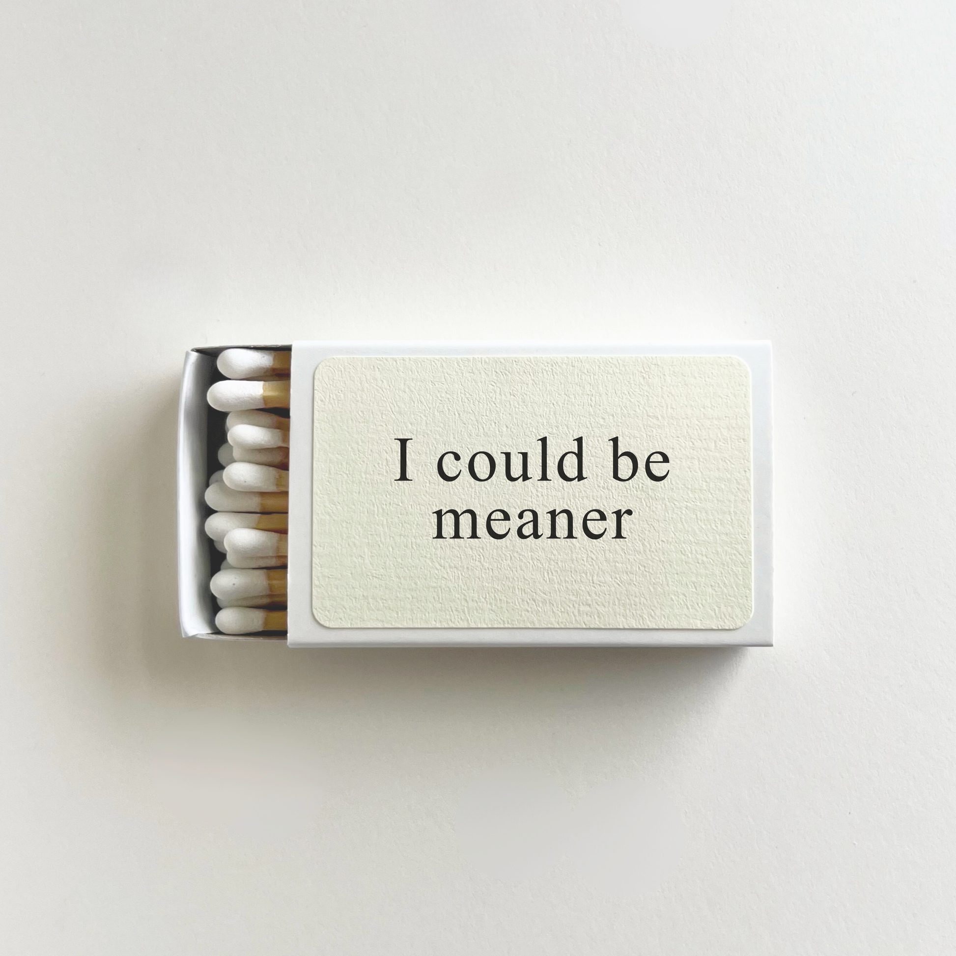 Matchbox with 'I could be meaner' text on a light background