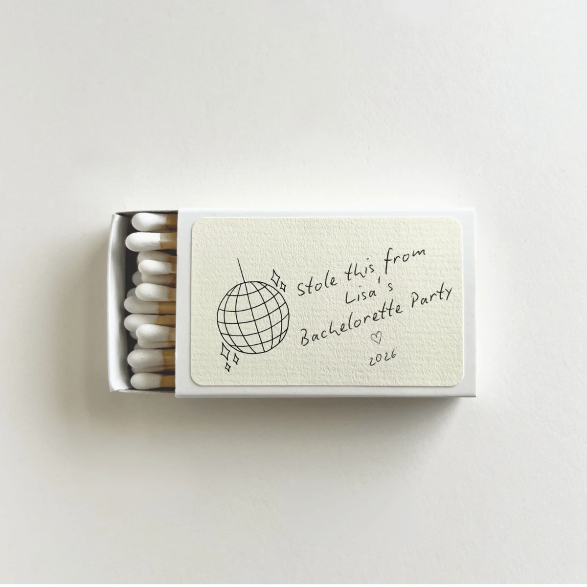 Personalized bachelorette disco ball matchbook open to show white-tip matches, disco ball illustration, and custom bride name on label