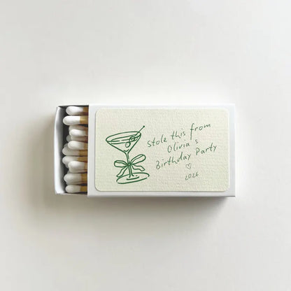Custom martini birthday matchbook opened to show white matches and personalized label